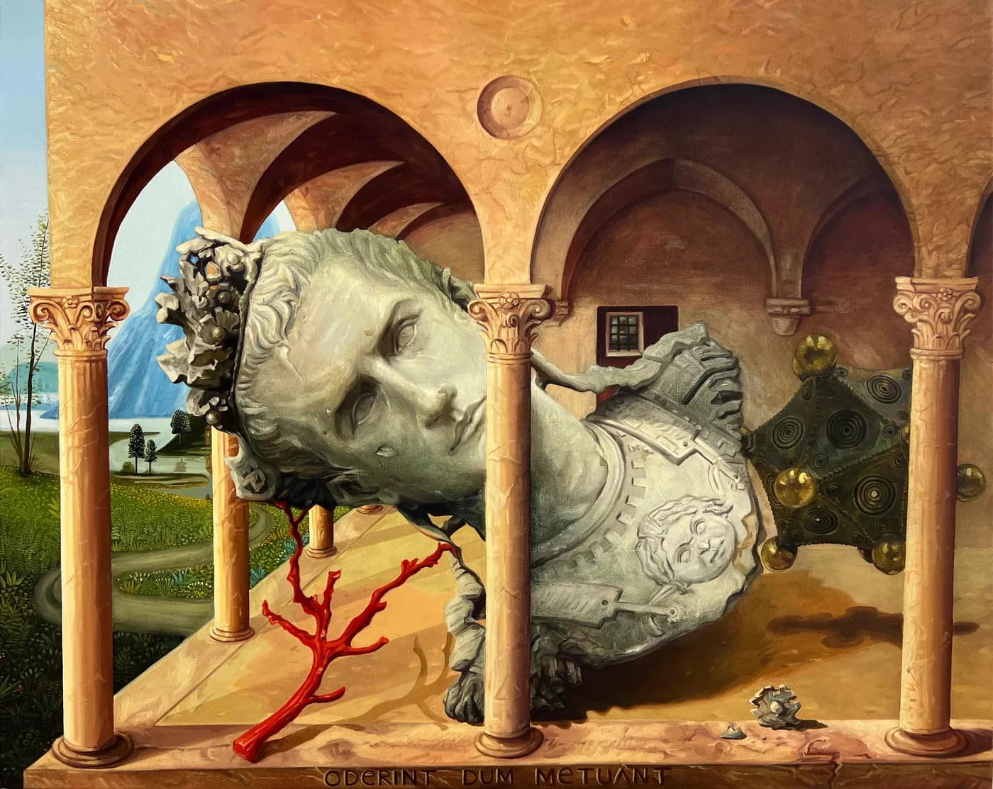 The crowned head and cuirassed torso of a Roman statue lie on their side beneath an arcade of arches and columns, a branch of red coral in the foreground and a mountain-and-lake landscape at left; along the ledge is inscribed “ODERINT DUM METUANT”.